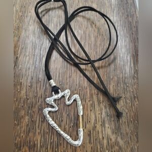 Large silver arrowhead on black suede cord. Go Chiefs